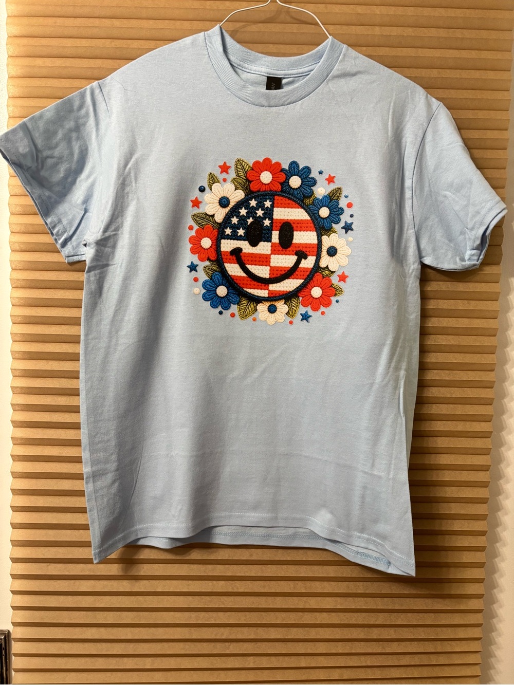 NEW size Medium Light Blue Tee with Patriotic Smiley Floral Graphic
